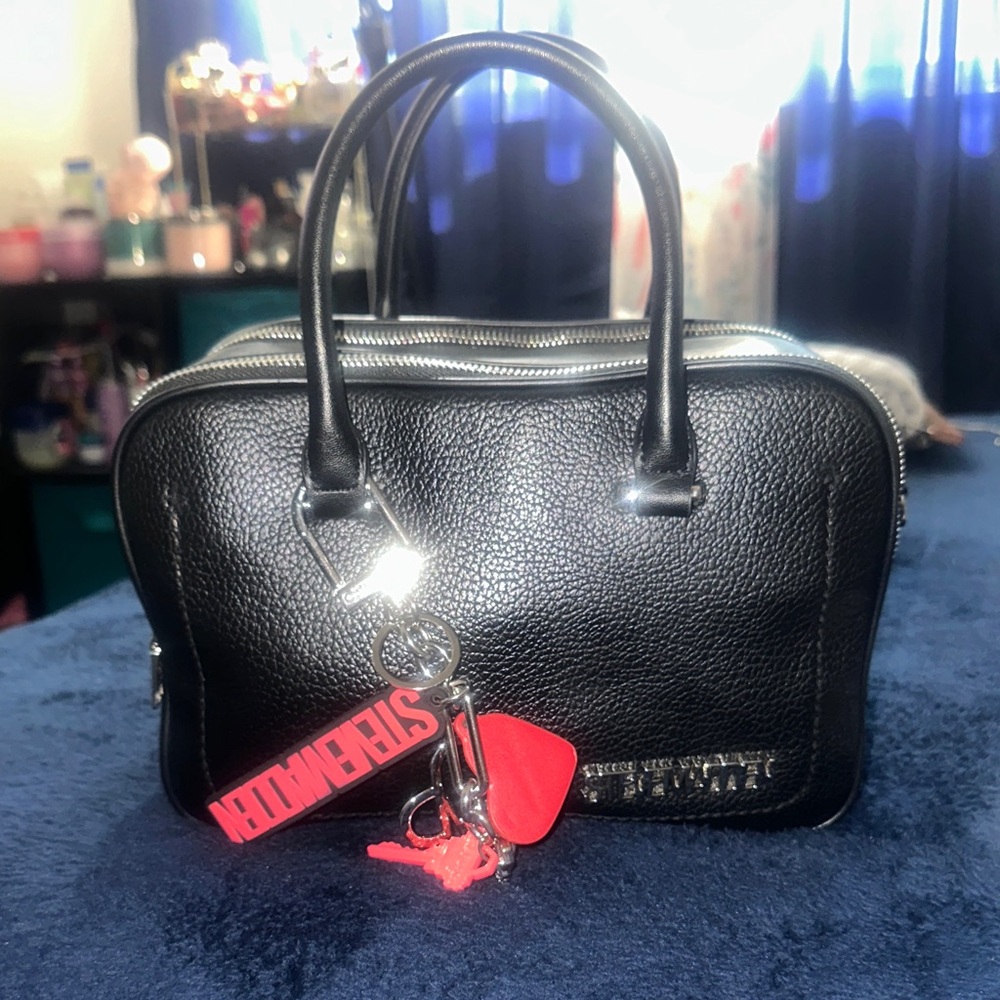 Stylish Black Handbag with Red Keychain